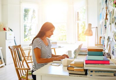 Indoor shot of a beautiful pregnant woman working at her modern home office.