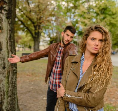 woman-and-man-wearing-brown-jackets-standing-near-tree-984954