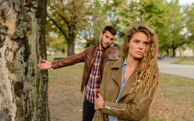 woman-and-man-wearing-brown-jackets-standing-near-tree-984954