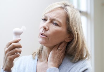 Mature Woman Experiencing Hot Flush From Menopause