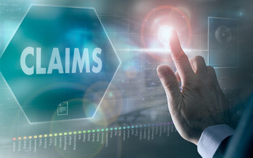 A businessman controlling a futuristic display with a Claims business concept on it.