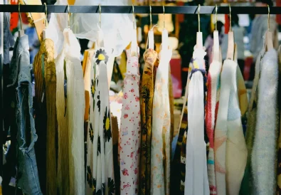 Colorful vintage clothing on display at an outdoor flea market
