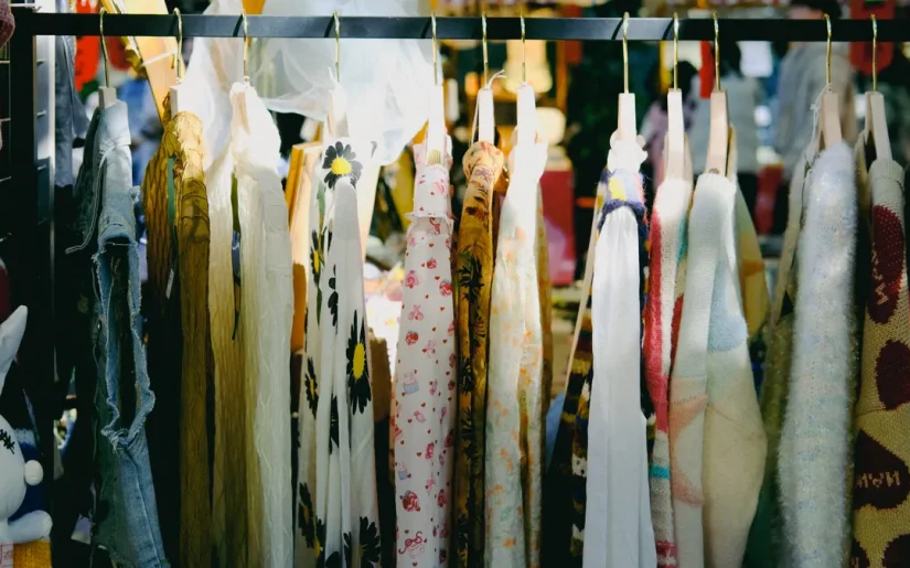 Colorful vintage clothing on display at an outdoor flea market