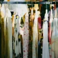 Colorful vintage clothing on display at an outdoor flea market
