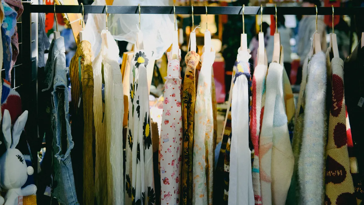 Colorful vintage clothing on display at an outdoor flea market