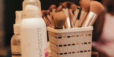 A collection of makeup brushes and beauty products neatly organized in a holder