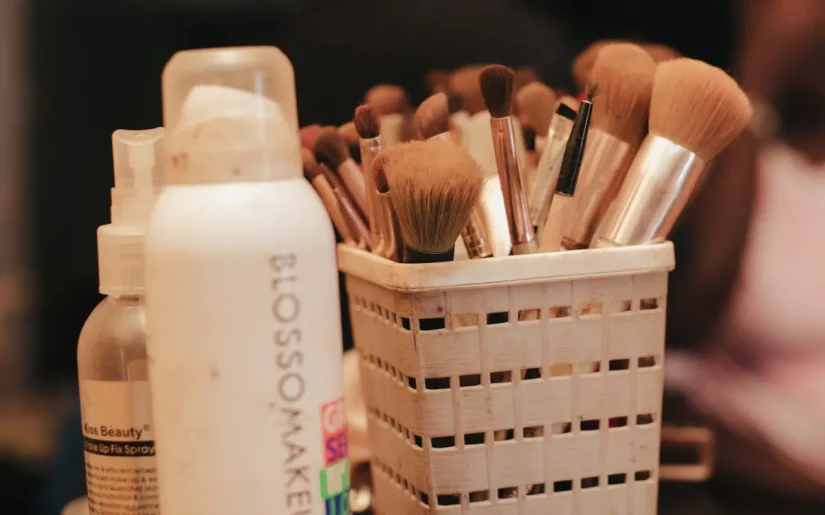 A collection of makeup brushes and beauty products neatly organized in a holder
