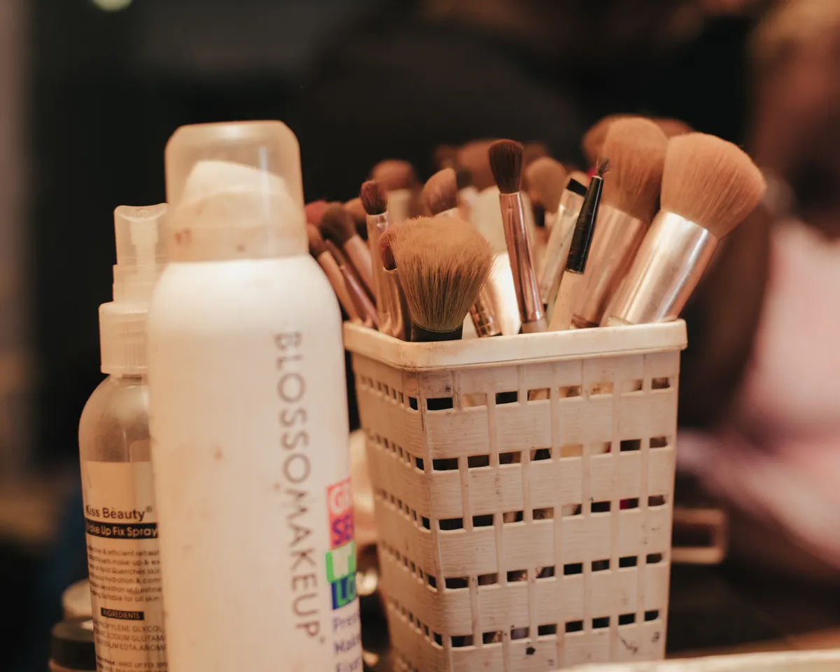 A collection of makeup brushes and beauty products neatly organized in a holder
