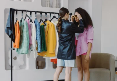 Fashion stylist assists client in a vibrant wardrobe fitting, ensuring perfect accessory choices