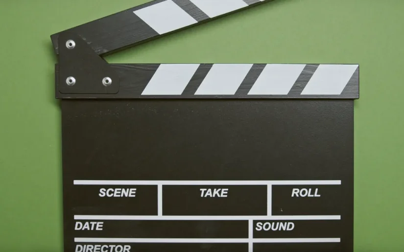 A classic film clapperboard on a green surface, essential for movie scenes
