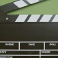 A classic film clapperboard on a green surface, essential for movie scenes