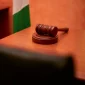A close-up of a gavel on a courtroom desk representing law and justice