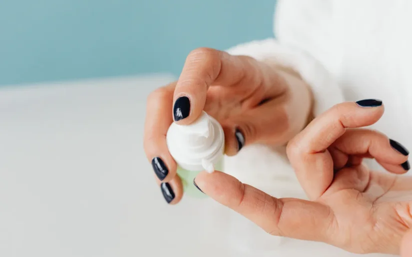 Detailed shot of hands applying skincare cream with gentle focus