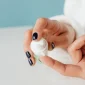 Detailed shot of hands applying skincare cream with gentle focus