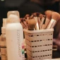 A collection of makeup brushes and beauty products neatly organized in a holder